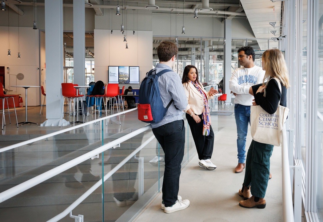 Four students chatting in the lobby of The Forum at Columbia University