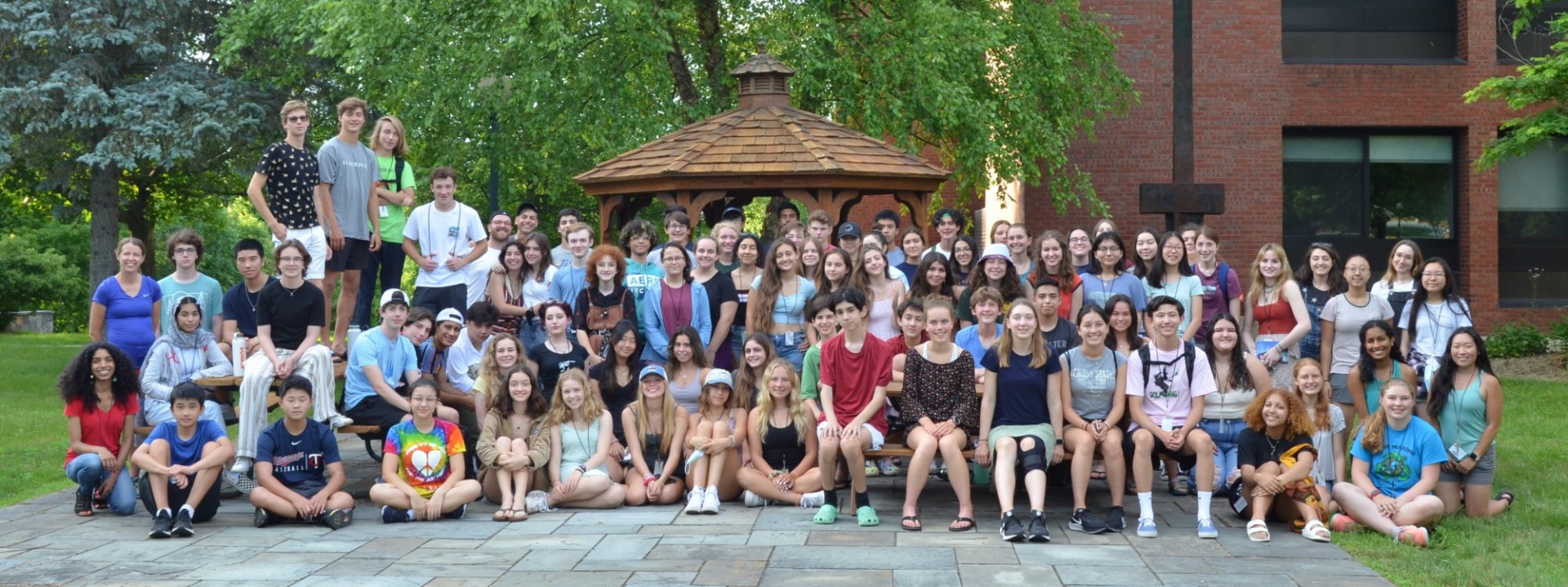 group photo of students outside in front of school building