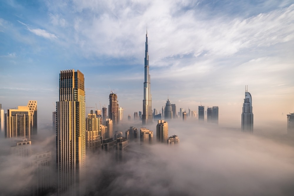 Downtown Dubai with skyscrapers submerged in thick fog (via Shutterstock).