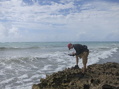 man standing in front of ocean waves