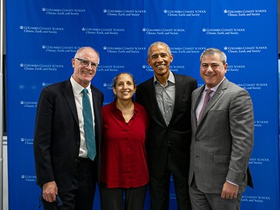 Alex Halliday, Ruth Defries, Barack Obama, and Jason Bordoff in front of blue background