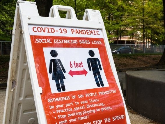 COVID-19 social distancing sign. Credit: dmbosstone/Flickr CC