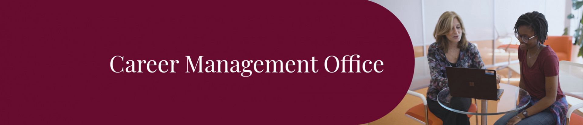 Two people sitting at a table looking at a laptop with the text Career Management Office