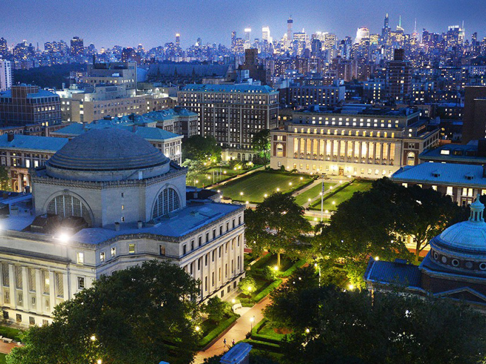 Overhead view of Columbia campus and skyline at night