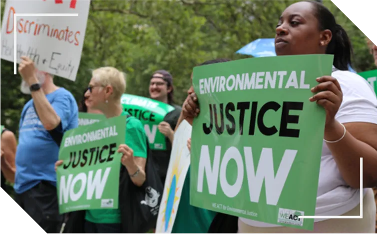 Group of people with signs reading Environmental Justice Now