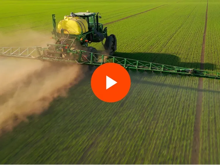Large farm equipment in a field of crops
