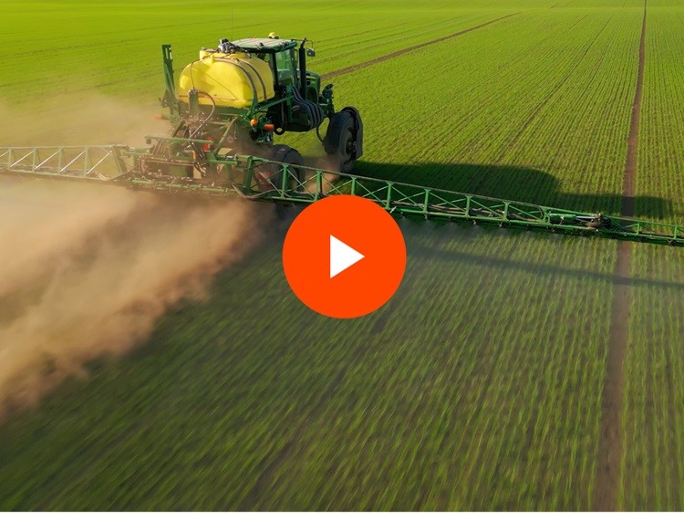 Large farm equipment in a field of crops