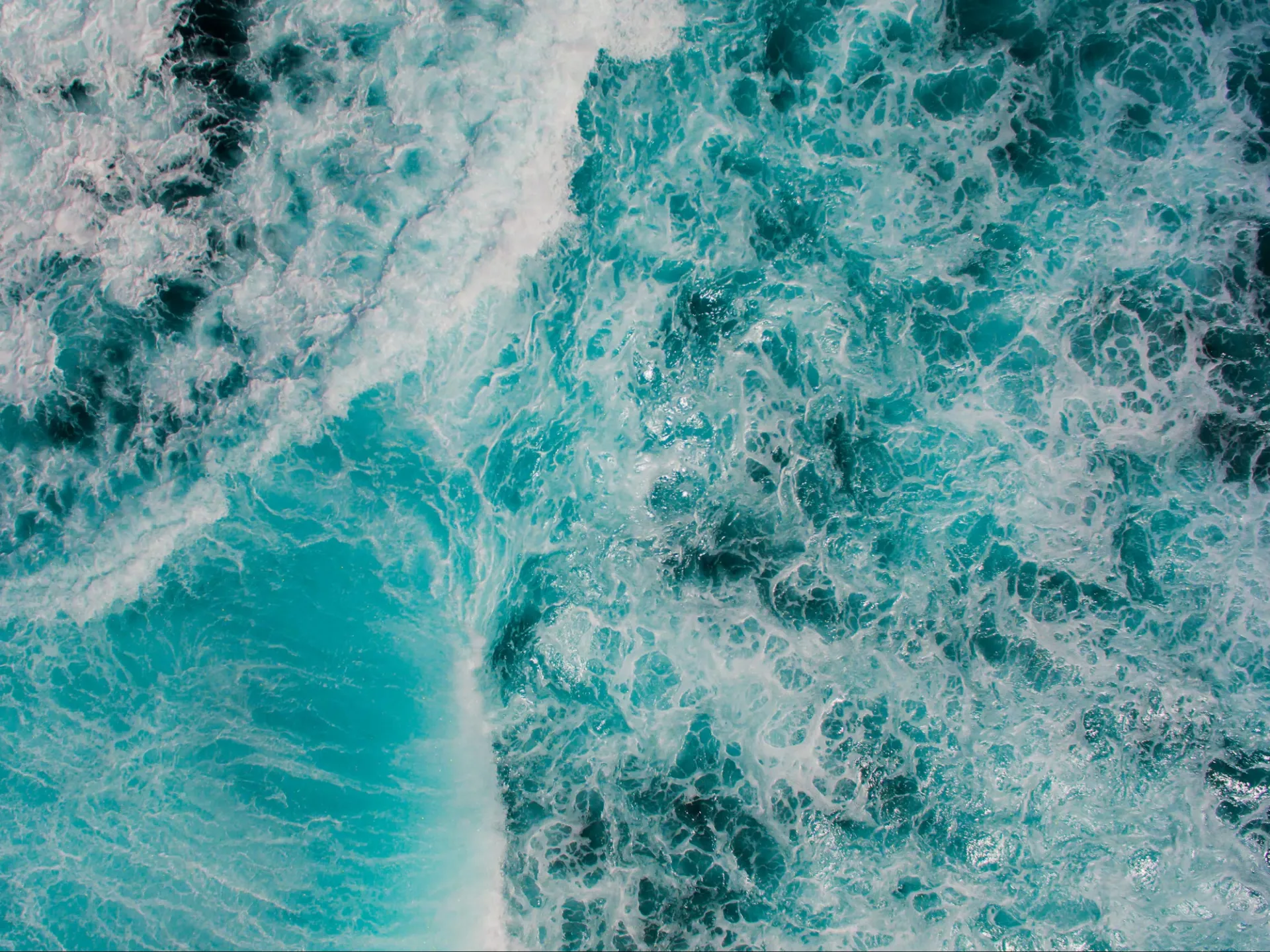 Overhead view of turquoise water and white waves