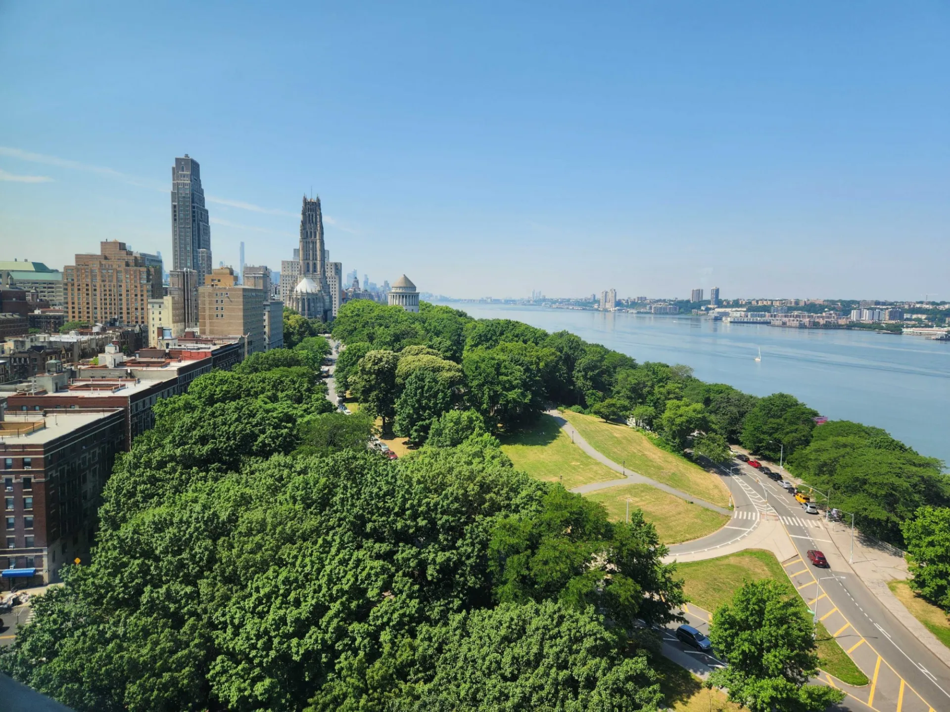 Aerial view of tree-covered NYC parkland and Hudson River. Credit: Roisin Commane