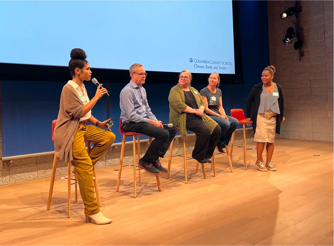 Five panelists on a stage