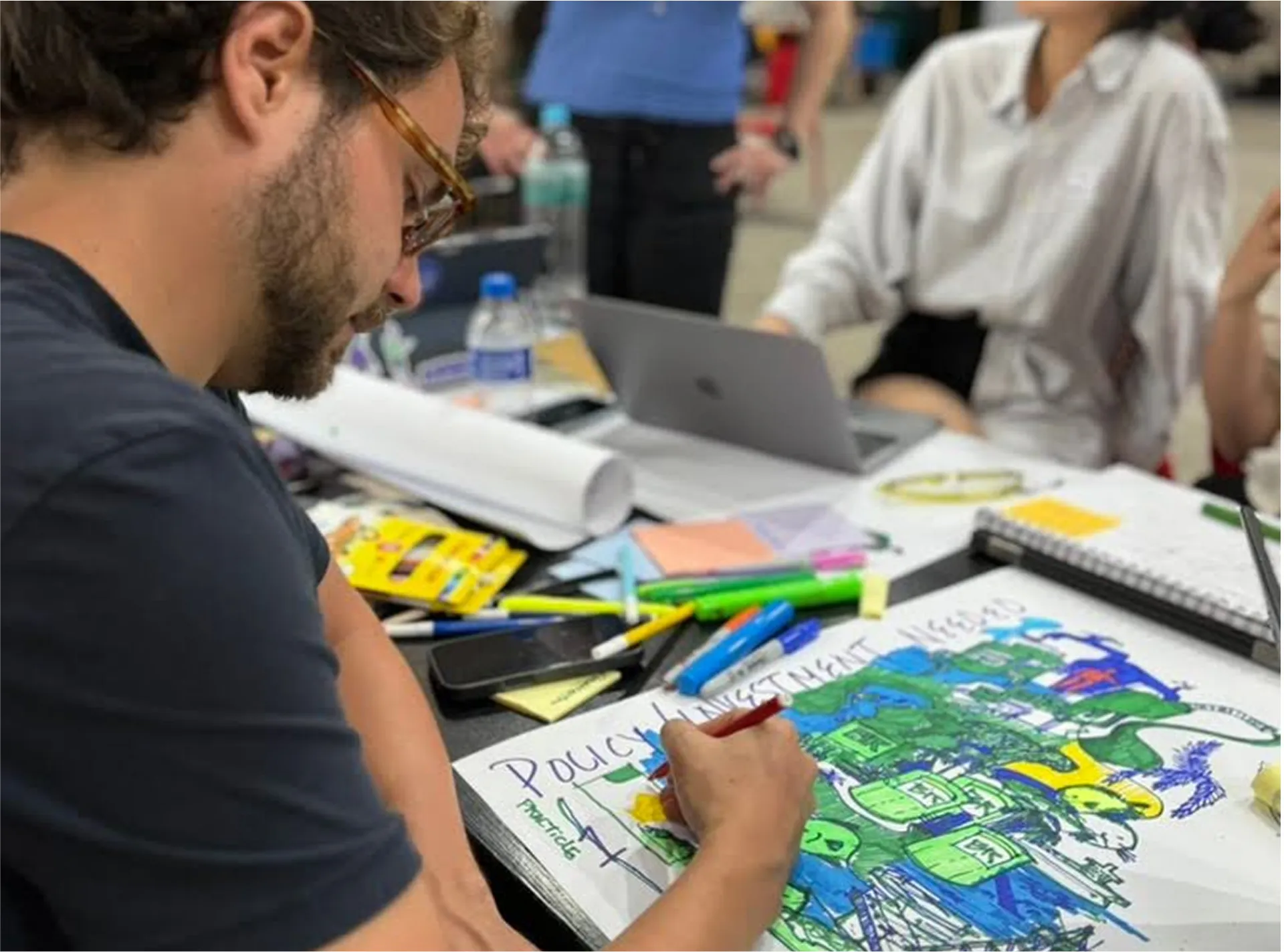 Person drawing a colorful map
