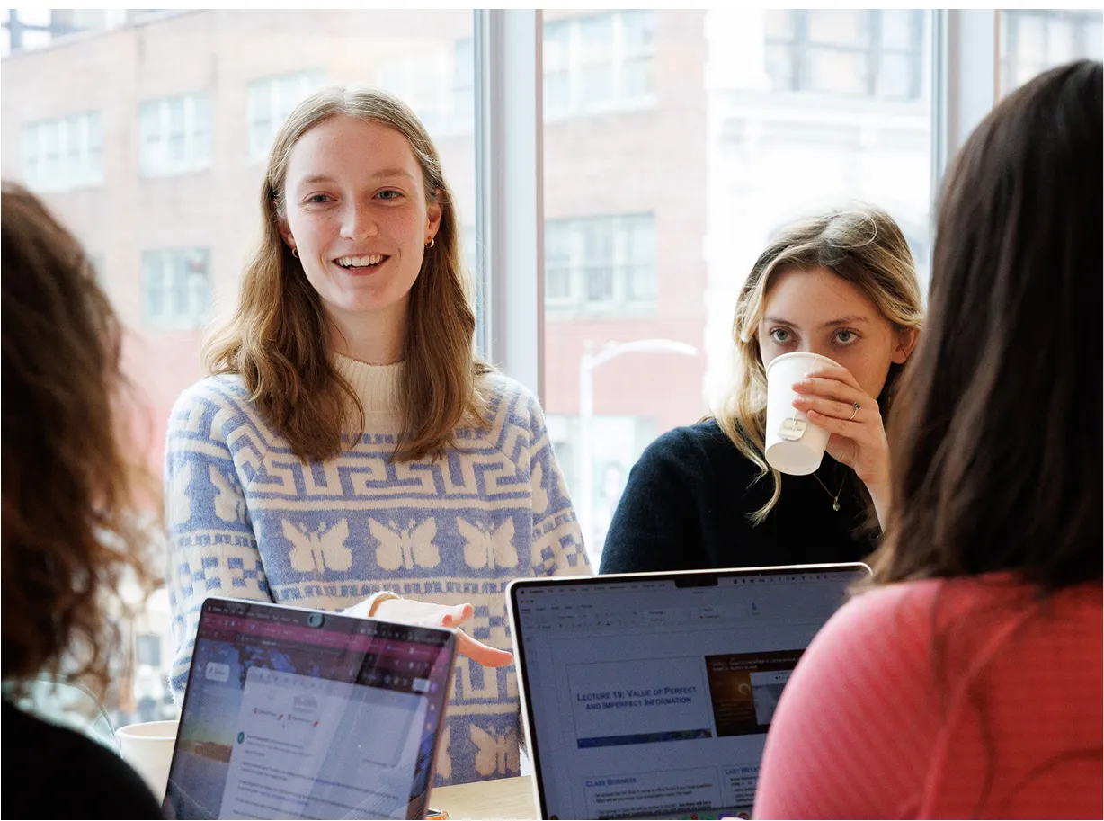 Smiling students with laptops