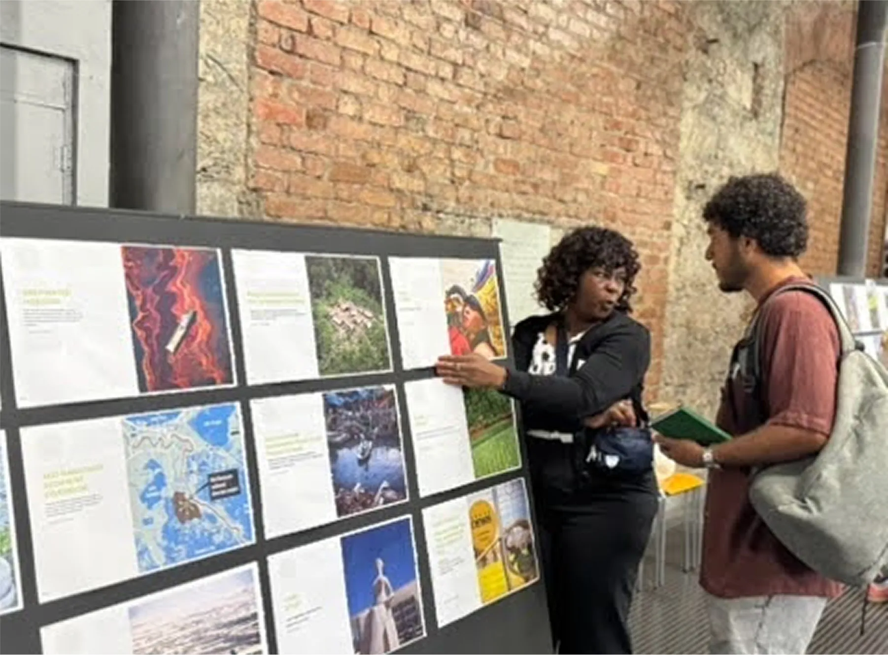 Student presenting a poster to another student
