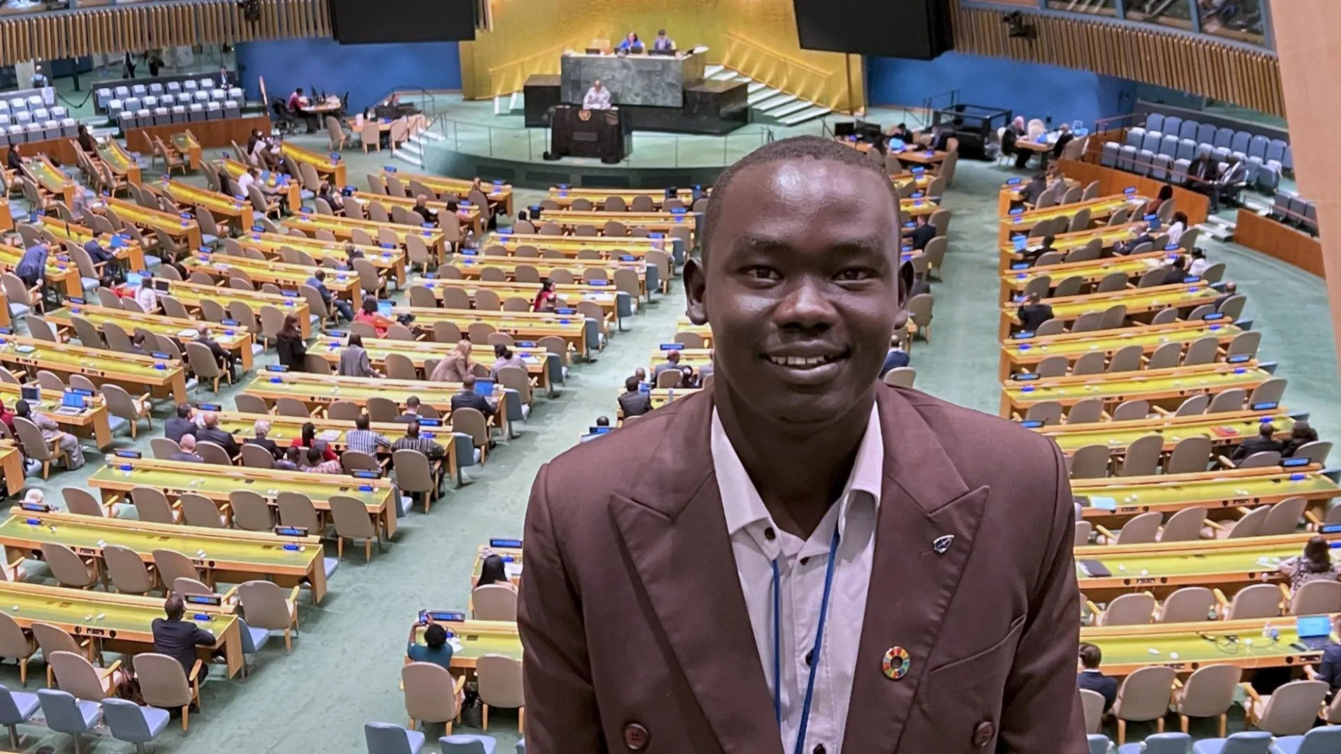 Anyieth Philip Ayuen in a large conference space.